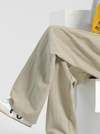 Men's casual loose fit pocket pants by Trendsi, comfortable stretch relaxed trousers with front pockets, suitable for everyday wear.