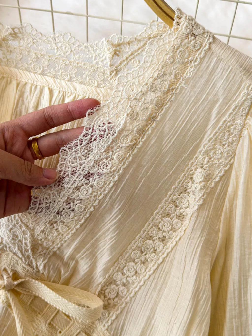 Lace detail V-neck blouse dress by Trendsi, featuring a flowy silhouette and elegant lace accents on the neckline.