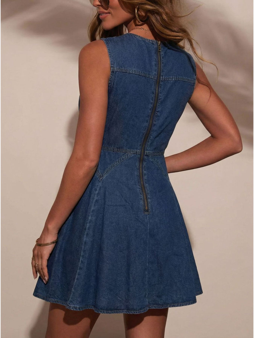 Women's sleeveless button-front denim mini dress made of stretchy cotton blend, featuring a fitted design and classic denim appearance.
