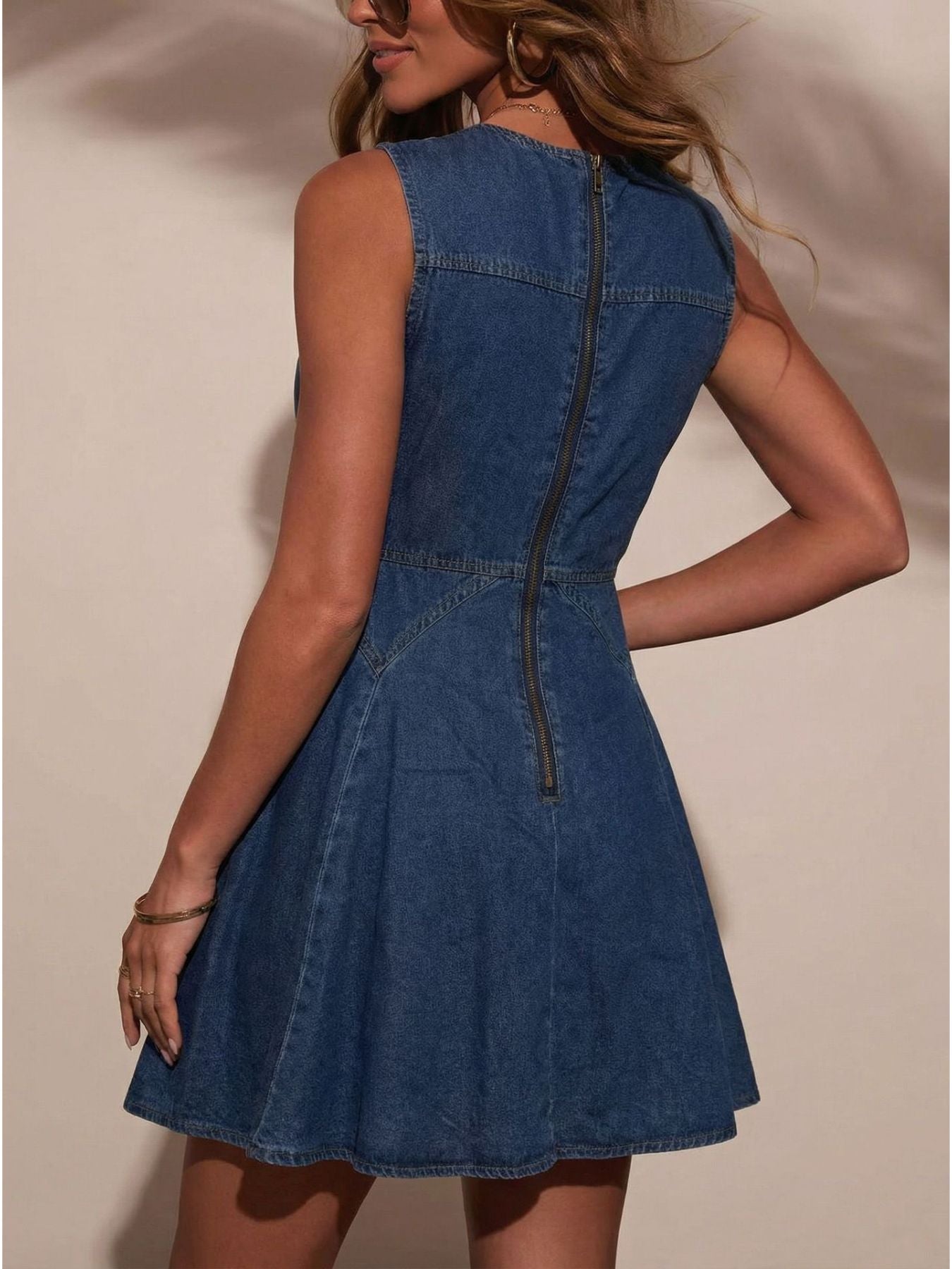 Women's sleeveless button-front denim mini dress made of stretchy cotton blend, featuring a fitted design and classic denim appearance.