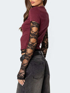 Women's fitted T-shirt by Trendsi featuring elegant lace sleeves, casual and sophisticated style, light-colored fabric.