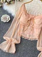 Women's elegant frill flounce sleeve smocked blouse made of lightweight polyester, stylish dress with feminine details.