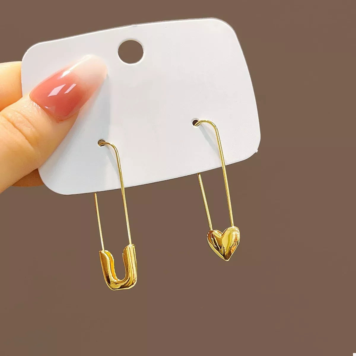 Gold-plated alloy heart safety pin drop earrings, stylish and elegant jewelry accessory with a romantic design.