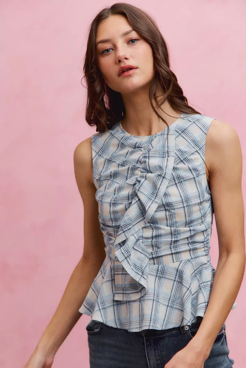 Plaid sleeveless ruffle peplum top from Plush Fashion Hub featuring a stylish plaid pattern and feminine ruffle details.