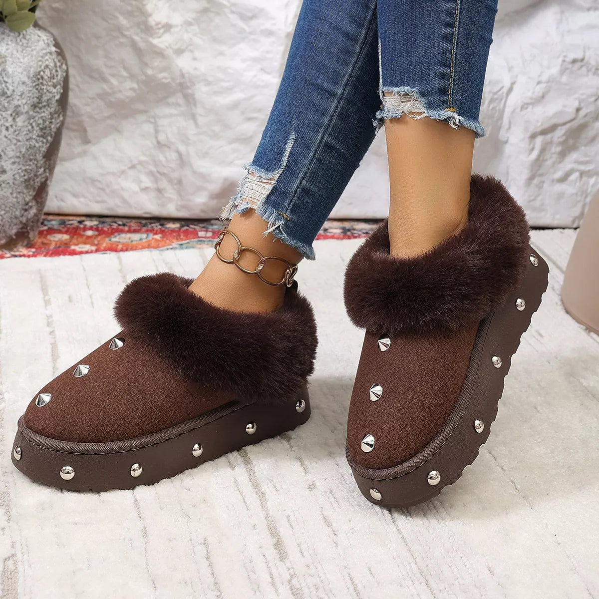 Black studded platform winter boots with faux fur lining and chunky soles, designed for cold weather and stylish winter wear.