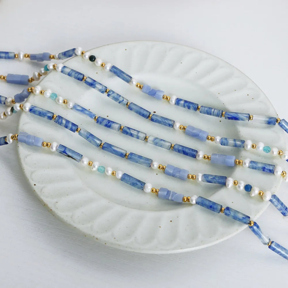 Freshwater pearl and titanium steel geometric bead necklace with modern design, featuring elegant beads and sleek metallic accents.