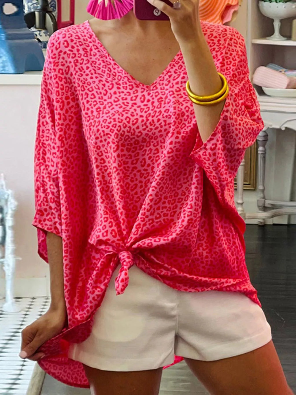 Women's leopard print V-neck blouse, trendy short sleeve animal print top, stylish dress by Trendsi.