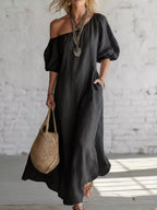 Elegant one-shoulder puff sleeve maxi dress by Trendsi, featuring flowing fabric and a stylish silhouette.