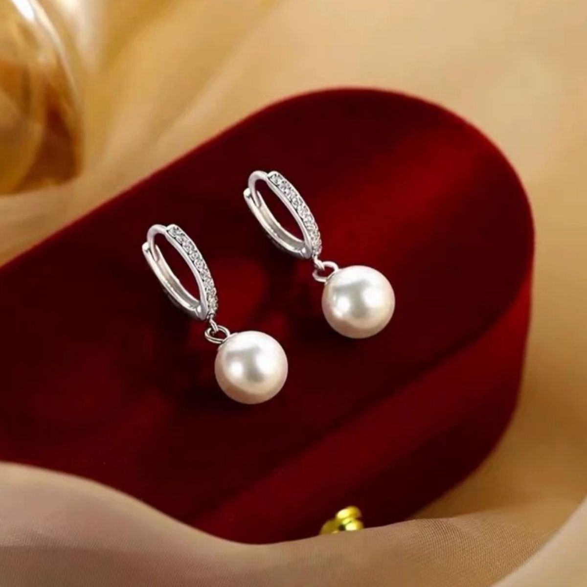 Pearl drop hoop earrings by Plush Fashion Hub featuring elegant gold hoops with dangling pearl accents.
