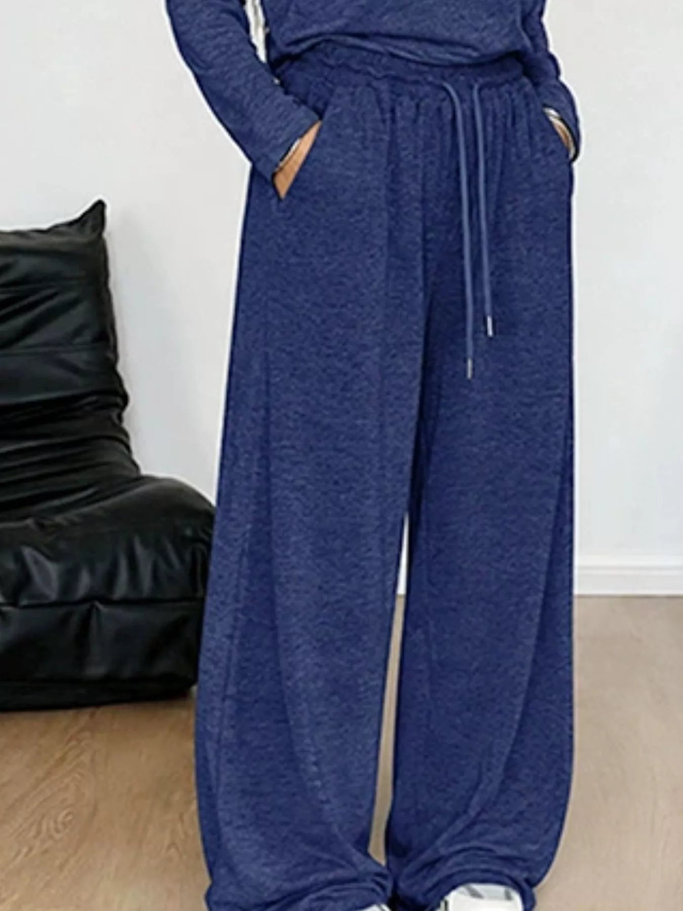 Plus size loose fit one-shoulder T-shirt and pants set by Trendsi, featuring comfortable, casual style in a relaxed fit.