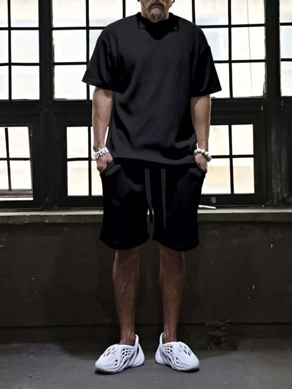 Plus size men's short sleeve top and shorts set by Trendsi, casual summer outfit, lightweight fabric, and relaxed fit shown in the image.