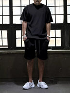 Plus size men's short sleeve top and shorts set by Trendsi, casual summer outfit, lightweight fabric, and relaxed fit shown in the image.