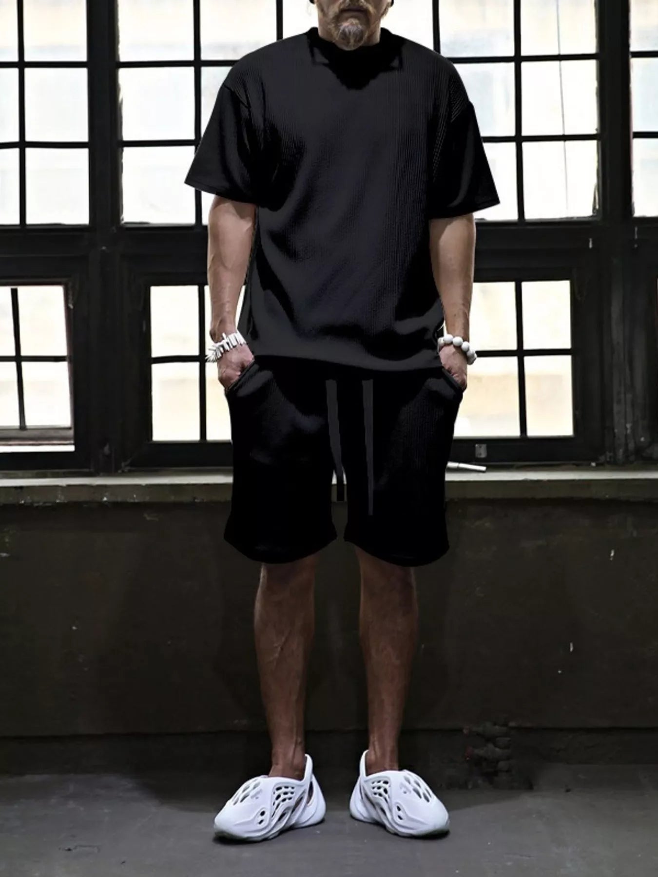 Plus size men's short sleeve top and shorts set by Trendsi, casual summer outfit, lightweight fabric, and relaxed fit shown in the image.