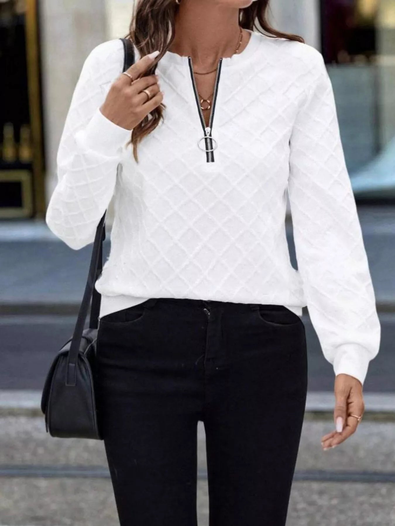 Textured quarter-zip sweatshirt by Plush Fashion Hub featuring plush fabric and stylish design, shown in a close-up view.