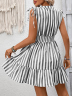 Women's striped smocked summer dress with ruffle hem, featuring a fitted bodice and flowing skirt, by Trendsi.