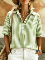 Women's striped short-sleeve shirt with turn-down collar from Plush Fashion Hub, featuring a classic collar and casual fit.