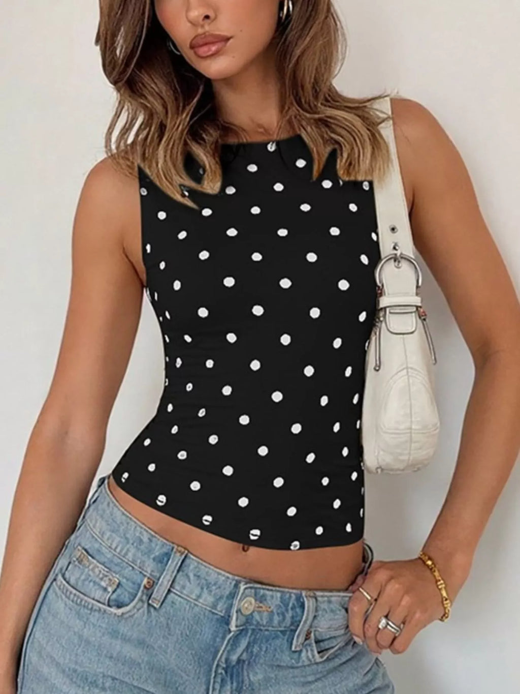 Shopimist polka dot tank top featuring a sleeveless design with a black and white dotted pattern on lightweight fabric.