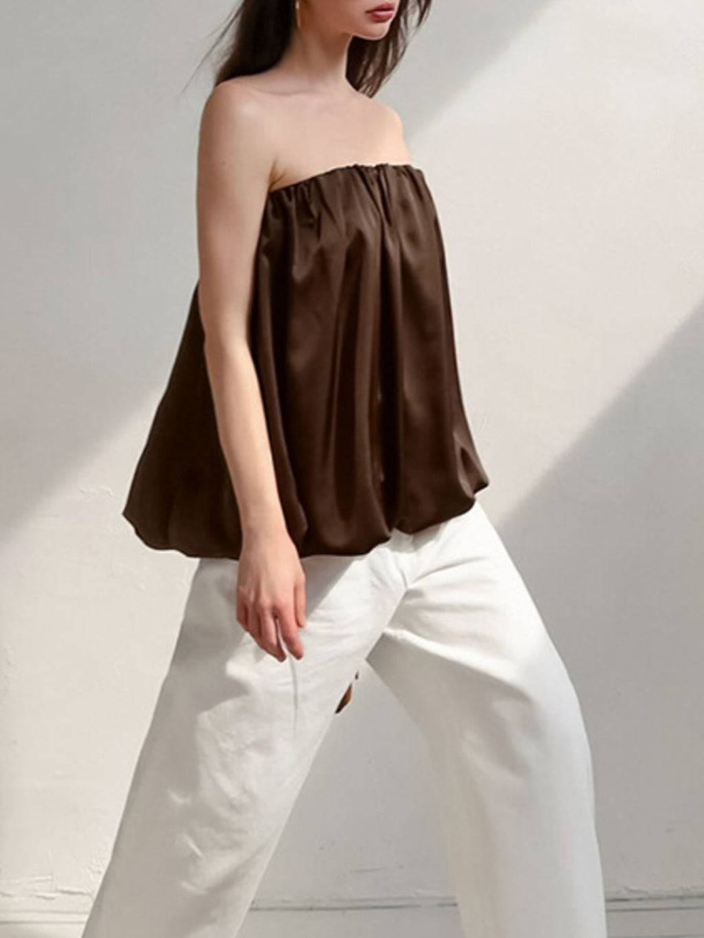 Women's strapless bubble hem tube top by Plush Fashion Hub, sleek minimalist crop top with a modern, fitted design.