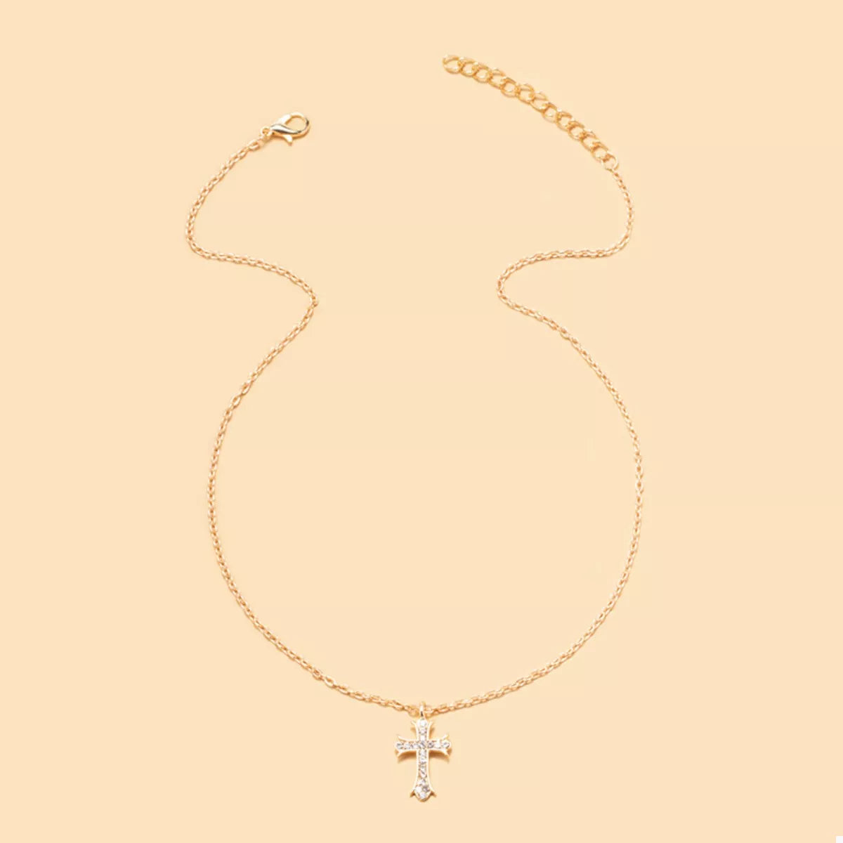 18K gold-plated rhinestone cross necklace with sparkling stones, featuring a delicate chain and detailed cross pendant.