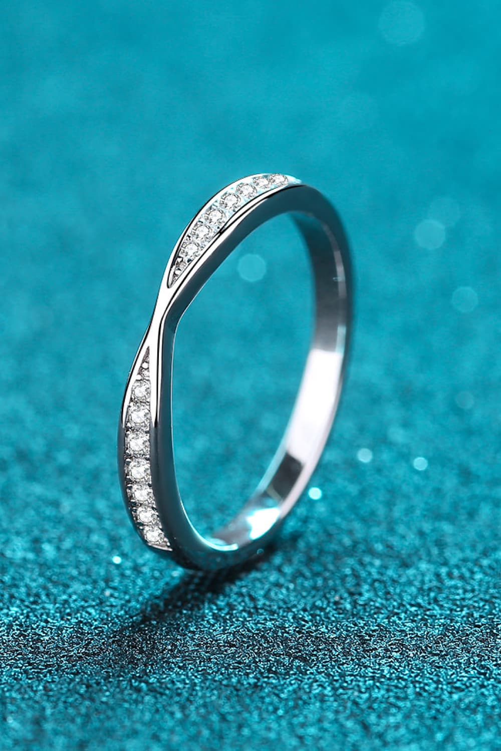 Rhodium-plated moissanite ring from Plush Fashion Hub showcasing a sparkling center stone and intricate band design.