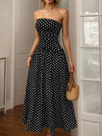 Polka dot strapless maxi dress by Shopimist featuring a flowing silhouette and a stylish, dotted pattern.