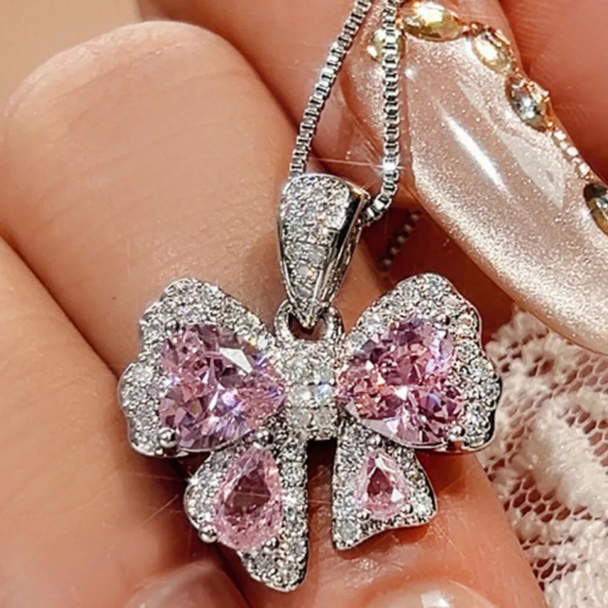 Zircon bow pendant necklace by Shopimist featuring a sparkling zircon stone in a delicate bow design, on a silver chain.