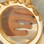 Sterling silver 1.5 carat moissanite ring with a sparkling center stone and intricate band design.