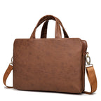 Handheld plush leather briefcase with one shoulder strap, designed for business use, from Plush Fashion Hub.