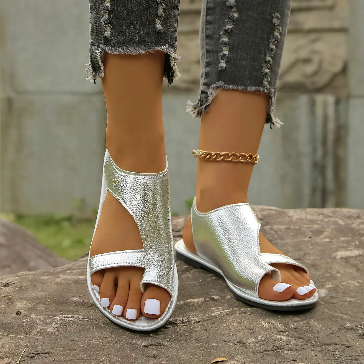 Shopimist toe loop flats sandals featuring a sleek design with open toes and minimalist straps on a white background.