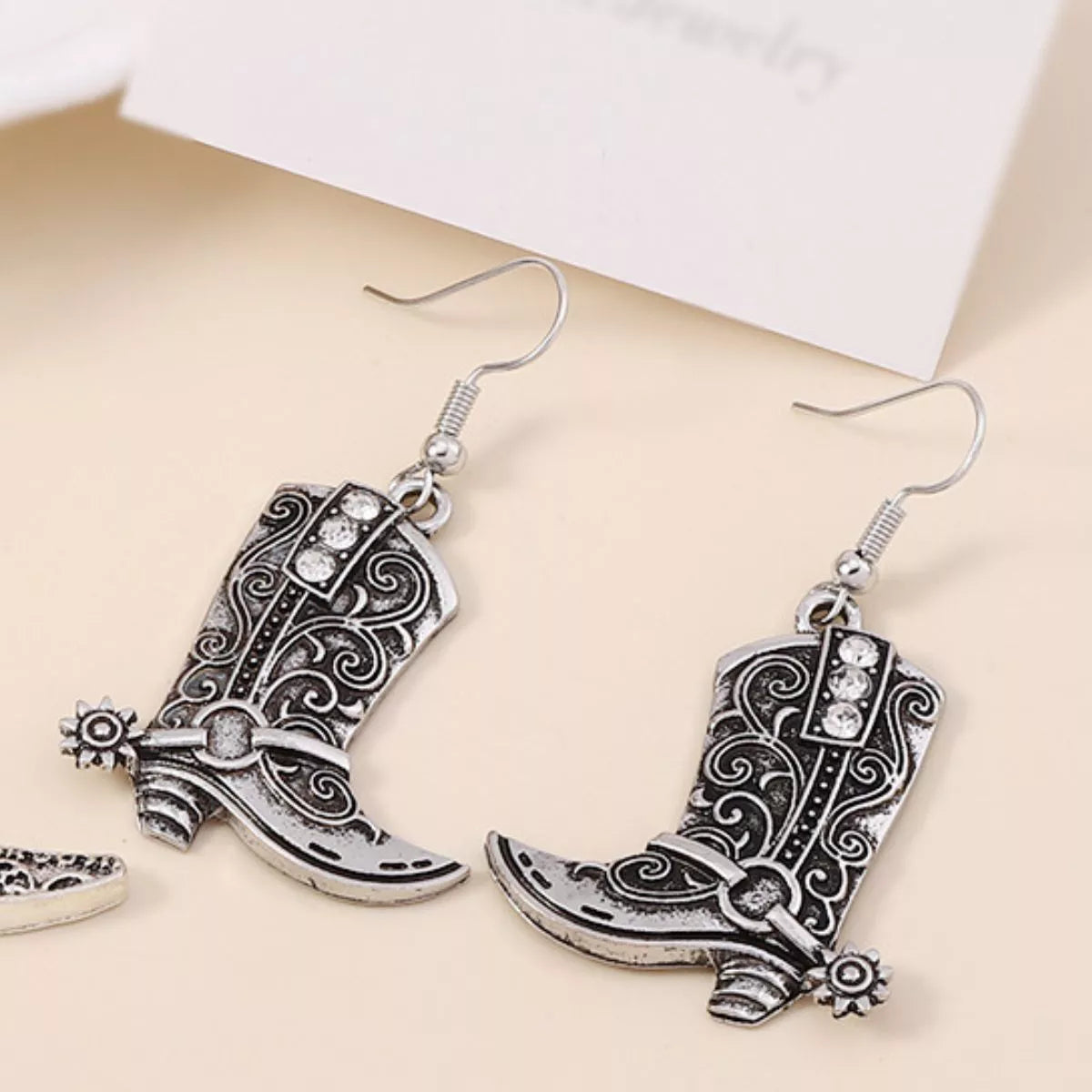 Vintage Western cowboy boot dangle earrings from Plush Fashion Hub with detailed boot design and rustic metal accents.