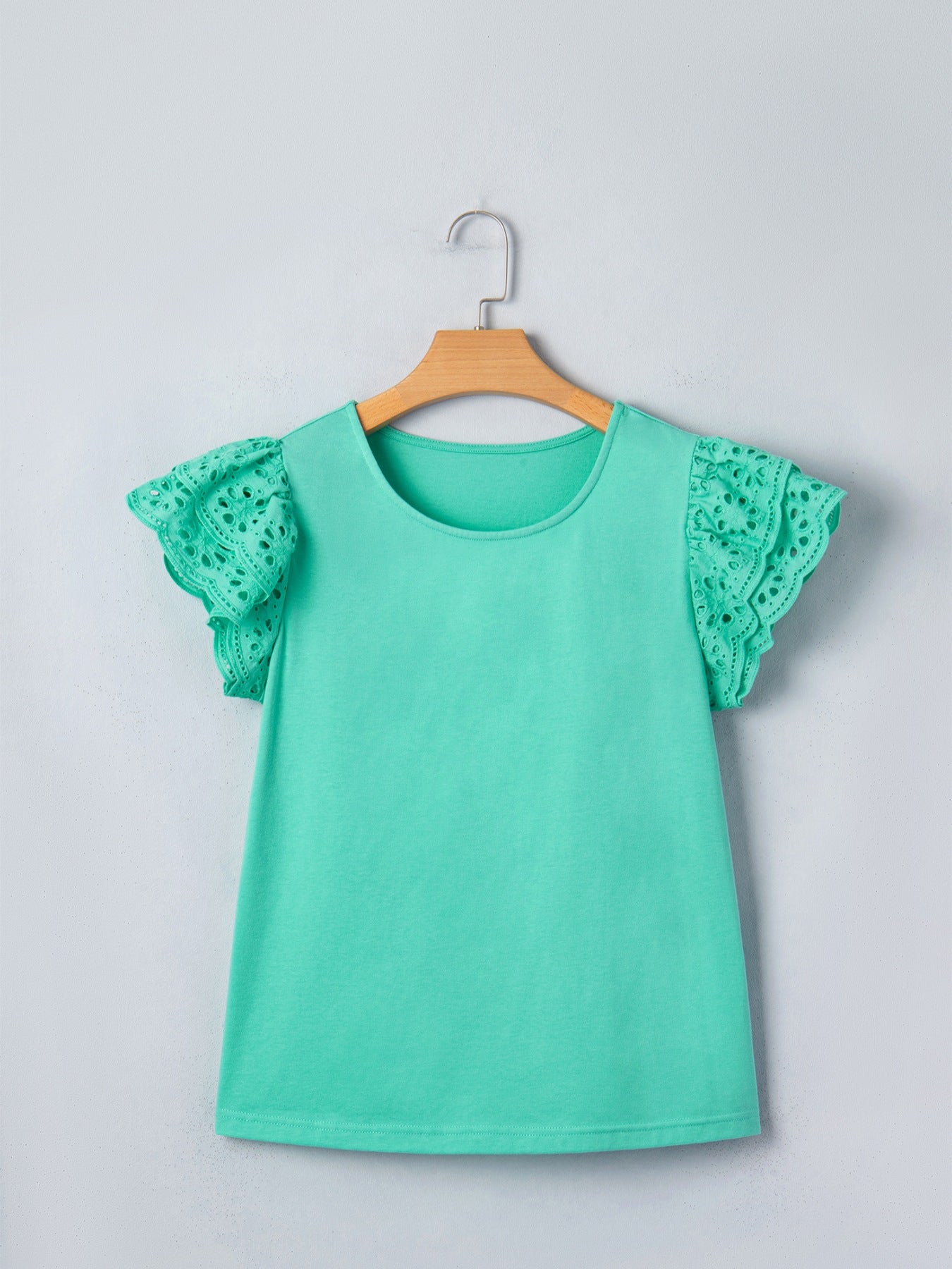 Ruffled eyelet lace cap sleeve top with cutout detail, featuring feminine design and intricate lace fabric, from Trendsi tops collection.