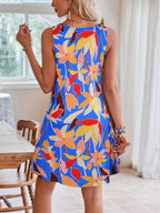 Tropical leaf print V-neck sleeveless dress by Shopimist, lightweight fabric with vibrant green and white leaf patterns.