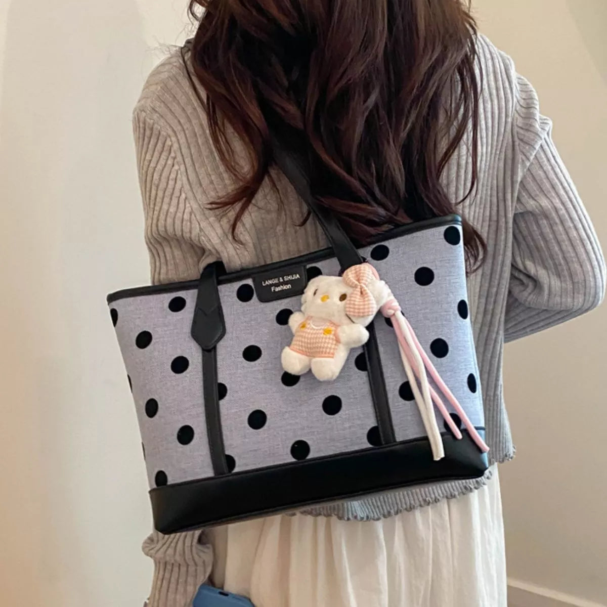 Polka dot shoulder handbag for women by Trendsi, showing a stylish black and white polka dot design with shoulder strap.