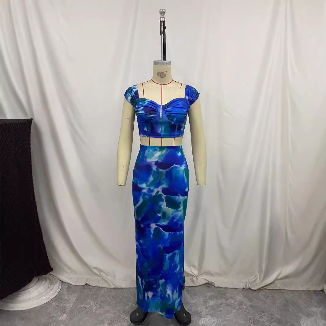Printed cropped camisole with straps and a figure-hugging maxi skirt, styled together for a chic, modern look.