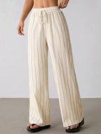 Striped wide-leg drawstring pants from Trendsi, featuring comfortable fit and stylish design with vertical stripe pattern.