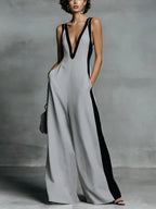 Deep V-neck wide-leg jumpsuit by Trendsi, stylish onesie with flowing fabric and sleek design, shown on a model.