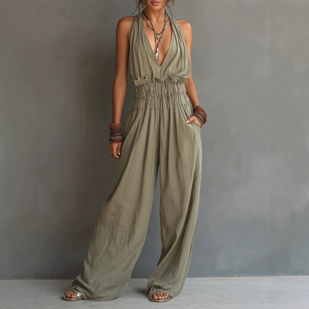 Women's sleeveless V-neck halter jumpsuit by Plush Fashion Hub featuring an open back and waist-cinching design.