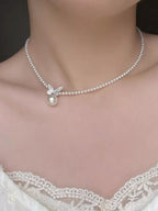 Pearl butterfly pendant necklace by Shopimist featuring a delicate pearl and butterfly charm on a silver chain.