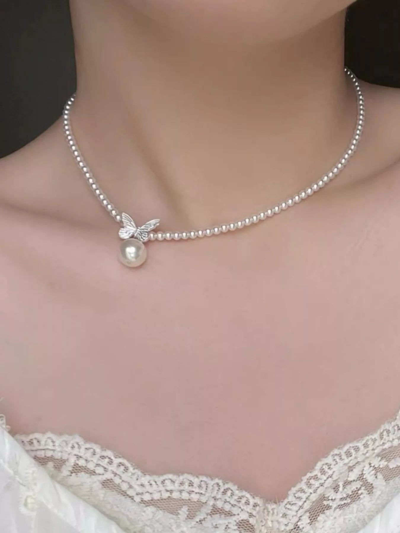 Pearl butterfly pendant necklace by Shopimist featuring a delicate pearl and butterfly charm on a silver chain.
