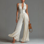 Sleeveless wide-leg high-waist pleated jumpsuit for women by FitiqueFit, featuring a minimalist long design and relaxed fit.