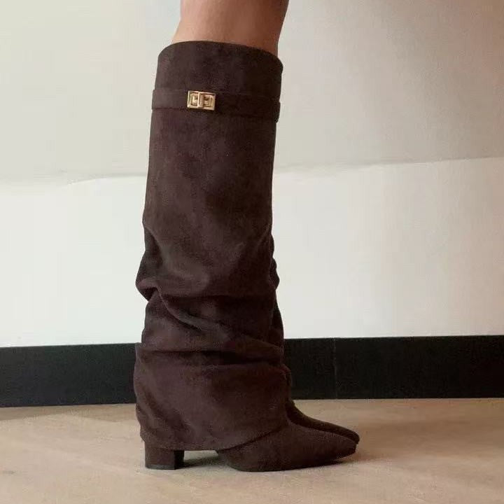Brown suede slouchy knee-high boots with a pointed toe, low block heel, and a gold-tone buckle strap detail.