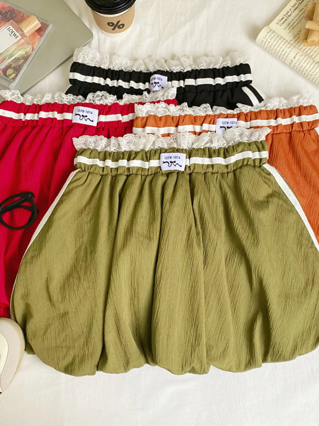 Lace trim elastic waist mini skirt from Trendsi, featuring a fitted style with delicate lace details and a comfortable stretch waistband.