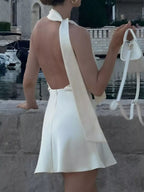 Shopimist halter neck mini dress with sleeveless design, fitted silhouette, and stylish neckline on a white background.