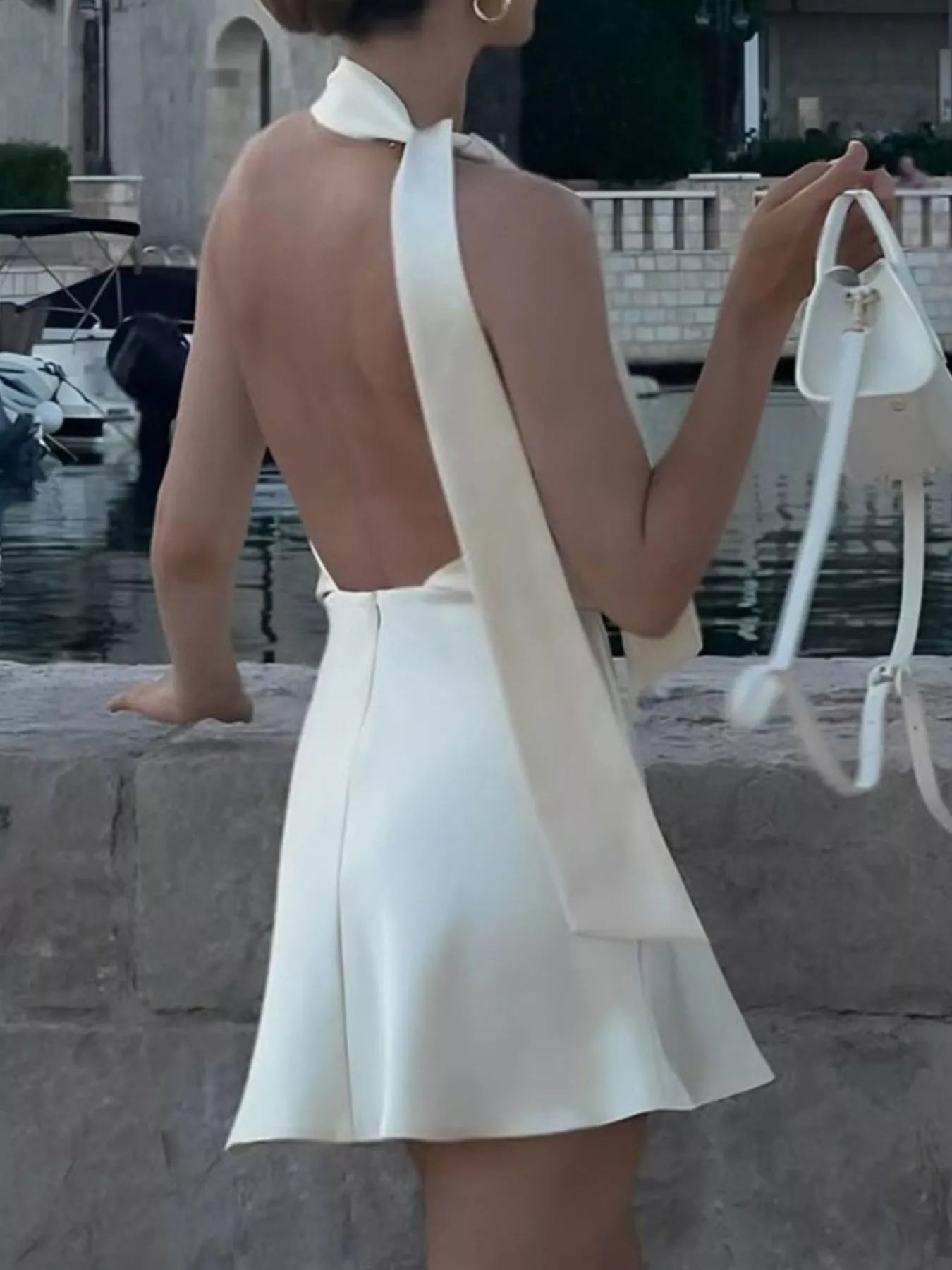 Plush Fashion Hub halter neck mini dress, sleeveless with fitted bodice and flared skirt, stylish for summer or casual occasions.