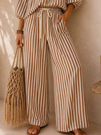 Plus size striped puff sleeve shirt and wide-leg drawstring pants set by Trendsi, featuring comfortable fabric and stylish design.
