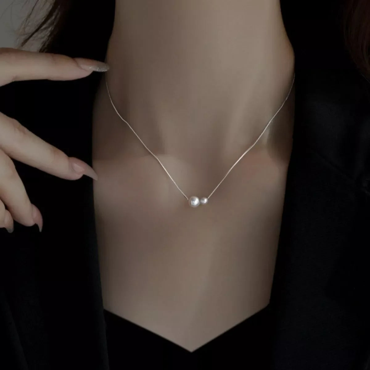 Sterling silver pearl necklace with lustrous white pearls on a delicate chain, elegant jewelry from Plush Fashion Hub.