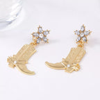 Western style boot dangle earrings by Shopimist featuring intricate cowboy boot designs on silver-toned metal.