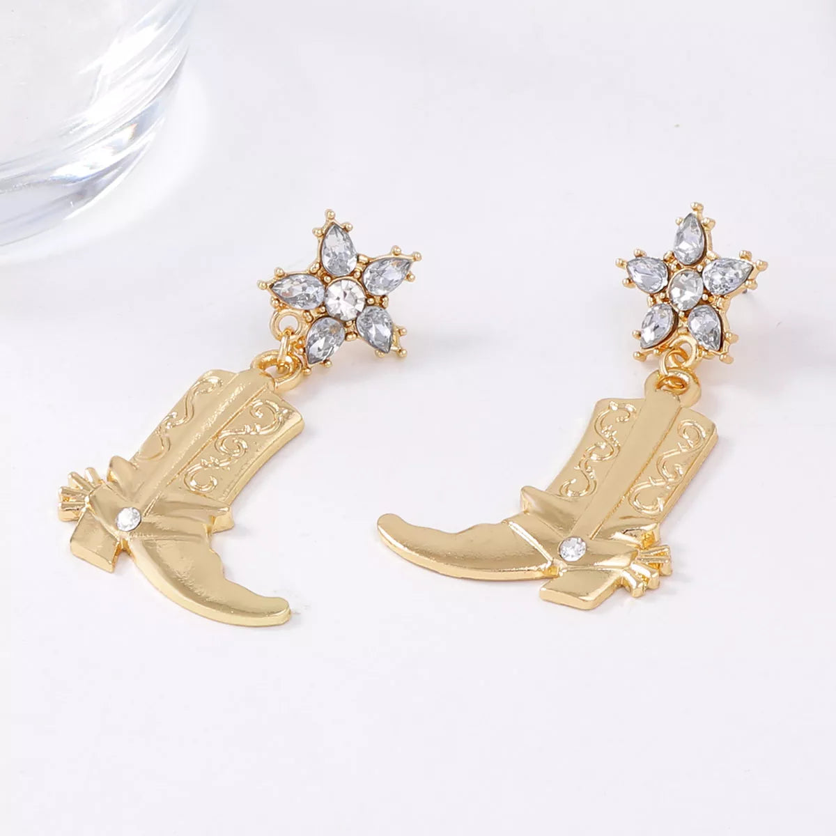 Western style dangle earrings with boot-shaped charms from Plush Fashion Hub, featuring detailed metal accents and a stylish design.