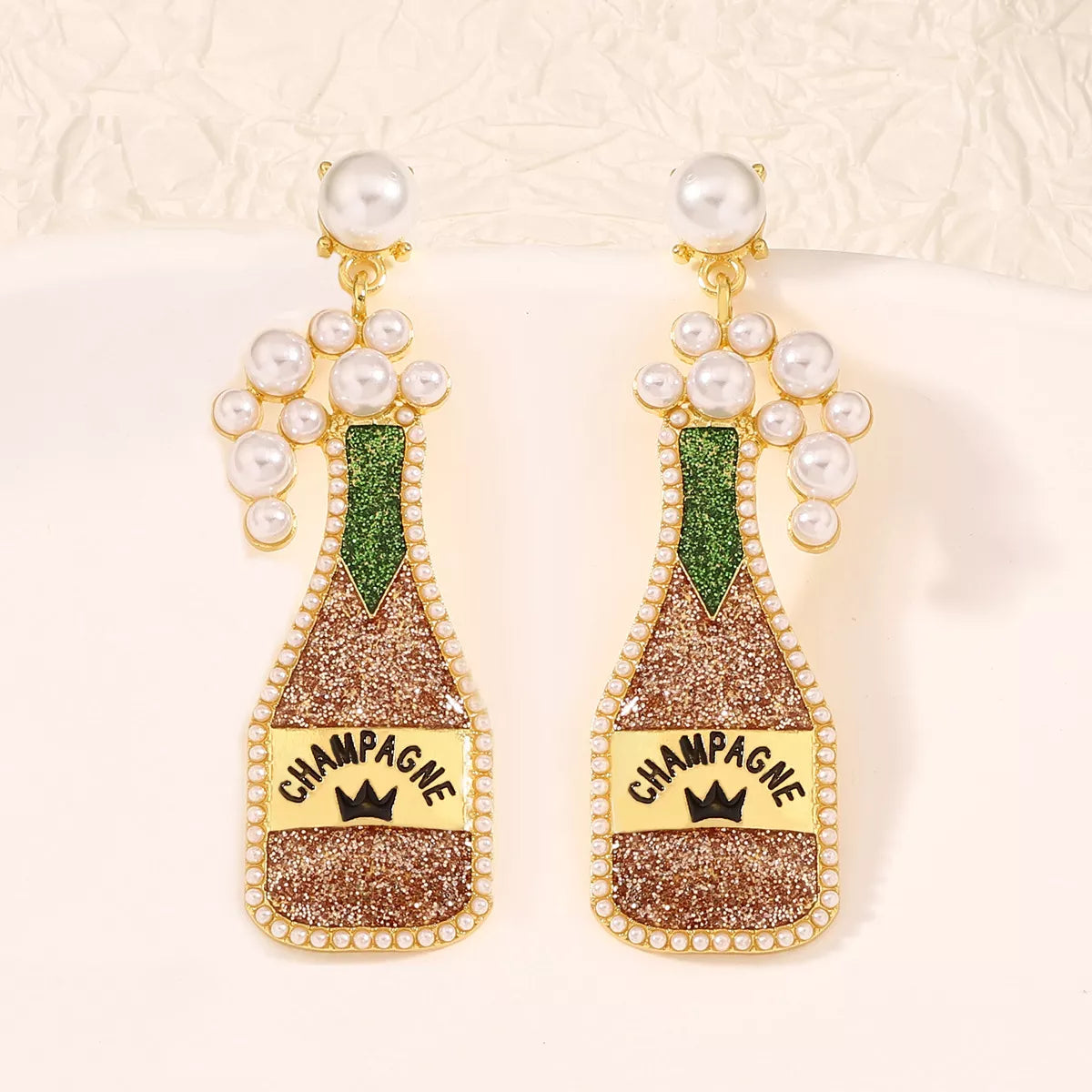 Champagne bottle earrings with pearl accents, stylish jewelry accessory from Shopimist, featuring detailed design and elegant charm.