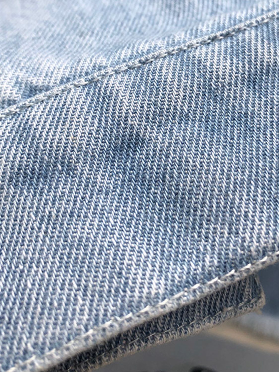 VYSN raw hem collared neck long sleeve denim jacket with classic style and button front, displayed on a hanger.
